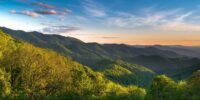 Springtime along the Blue Ridge Parkway in North Carolina. Looking south the colors of sunset are just starting to appear as the sun gets closer and closer to the horizon.